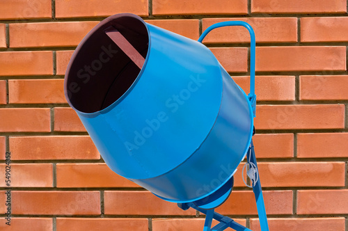 concrete mixer on the background brick wall photo