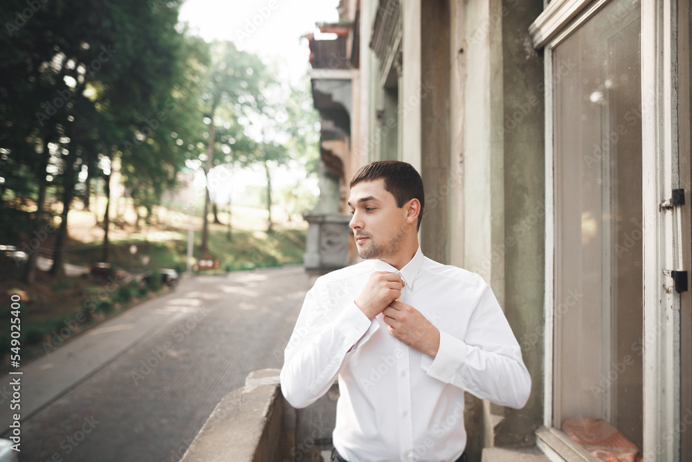 Fototapeta premium Beautiful man, groom posing and preparing for wedding