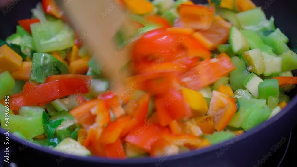 Cooking vegetable stew with peppers, carrots, zucchini and celery. Shuffles in close-up. Homemade Veggie food Cooking vegetable stew with peppers, carrots, zucchini and celery. Shuffles in close-up. Homemade Veggie food