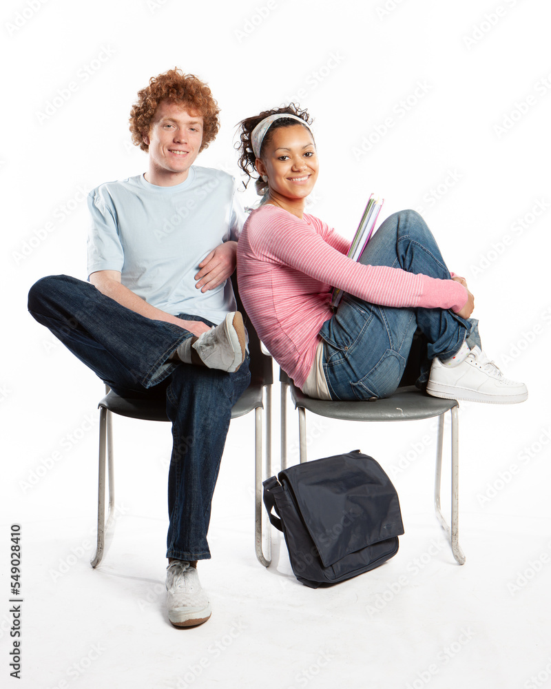 Teenagers: School Friends. A pair of late teenage school friends sitting in a comfortable and relaxed mood together. From a series of related images. Teenagers: School Friends. A pair of late teenage school friends sitting in a comfortable and relaxed mood together. From a series of related images.