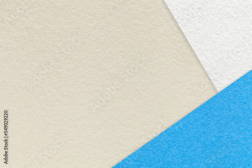 Texture of craft light beige color paper background with blue and white border. Vintage abstract sand cardboard.