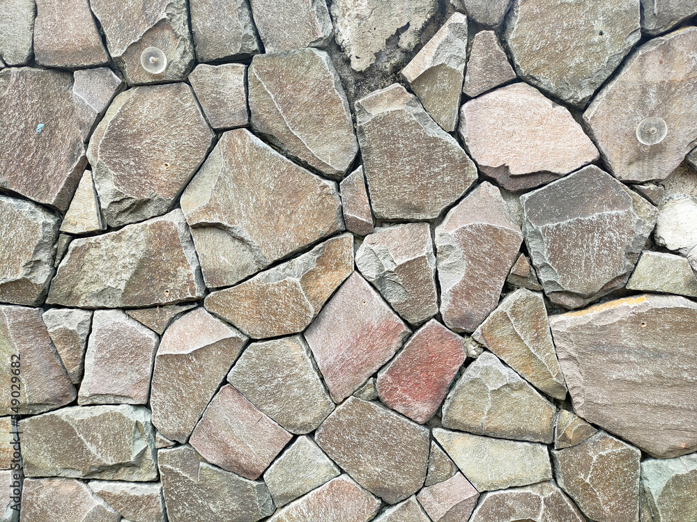 Granite stone wall surface. These stones have been joined together using mortar. The construction of this wall requires precision so that it can be built upright with an almost flat surface.
Granite stone wall surface. These stones have been joined together using mortar. The construction of this wall requires precision so that it can be built upright with an almost flat surface.