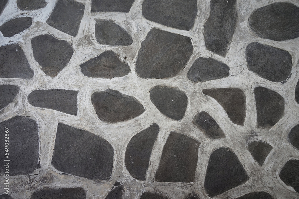 Fototapeta premium Pattern or arrangement of stones connected with concrete for vintage or abstract background