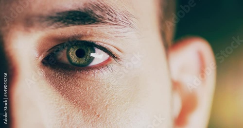 Vision, eyes and portrait of man opening eye, blink and dilate pupil for eye test. Healthcare, medical insurance and eyesight, male model with green eyes looking, focus and zoom on blurred background photo