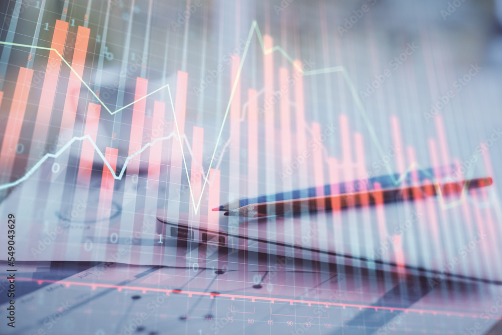 Forex graph hologram on table with computer background. Double exposure. Concept of financial markets. Forex graph hologram on table with computer background. Double exposure. Concept of financial markets.