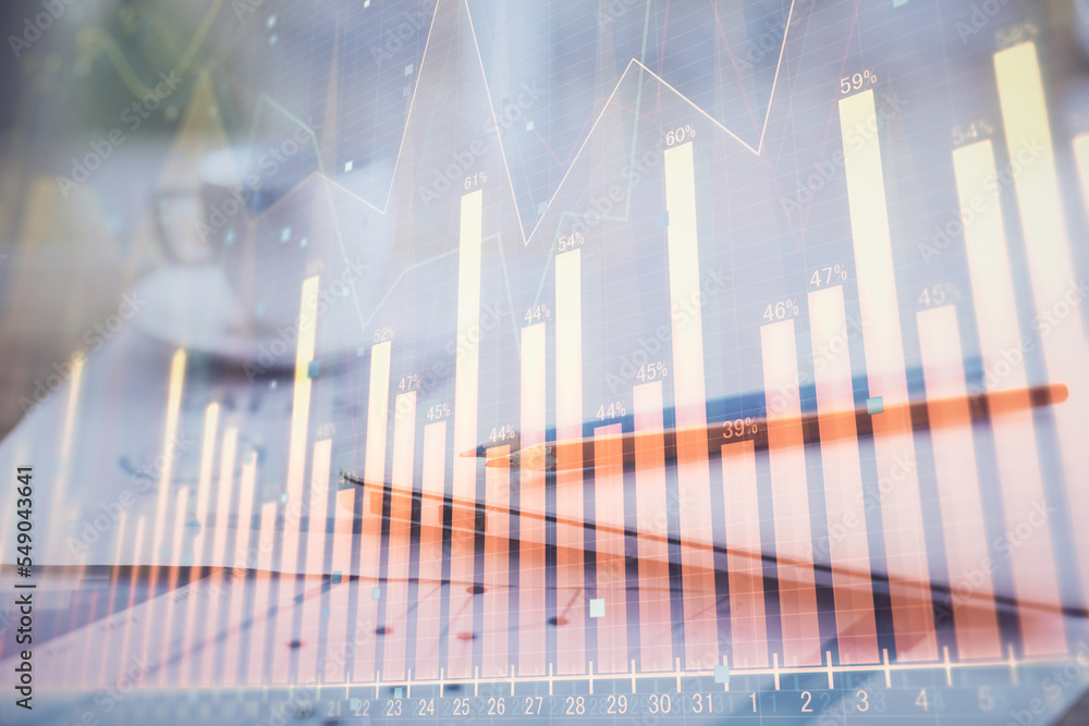 Forex graph hologram on table with computer background. Double exposure. Concept of financial markets. Forex graph hologram on table with computer background. Double exposure. Concept of financial markets.