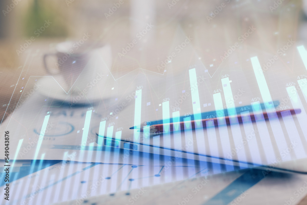 Forex graph hologram on table with computer background. Double exposure. Concept of financial markets. Forex graph hologram on table with computer background. Double exposure. Concept of financial markets.