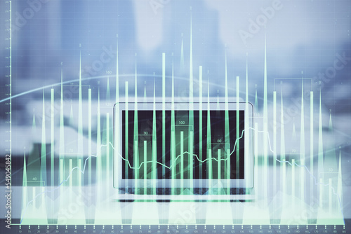 Forex graph hologram on table with computer background. Multi exposure. Concept of financial markets. © peshkova