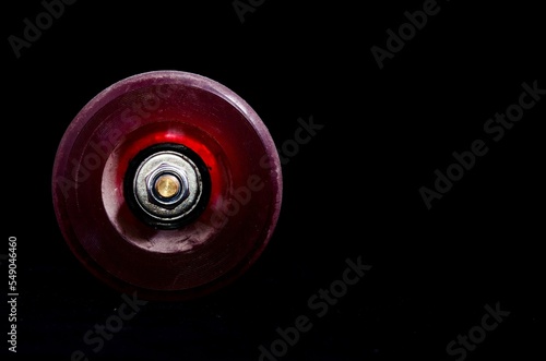 Photography Closeup shot of an old vintage consumed skate wheel on a black background