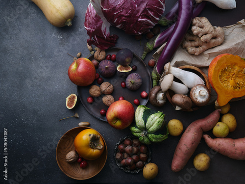 Top view winter groceries, healthy vegetarian ingredients for cooking a dinner on a dark background