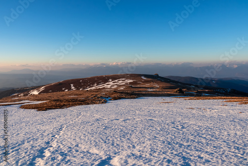 Scenic view of snow covered alpine meadows and Karawanks mountains at sunrise seen from Ladinger Spitz, Saualpe, Lavanttal Alps, Carinthia, Austria, Europe. Traces in hiking trail from ski touring
