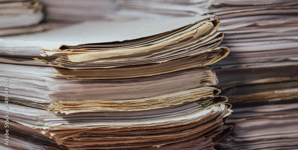Stack of blank papers with binder clips on wooden table indoors. Workplace. Many documents, contracts, legal agreements, papers on work table. Concept of business, working, job Stack of blank papers with binder clips on wooden table indoors. Workplace. Many documents, contracts, legal agreements, papers on work table. Concept of business, working, job