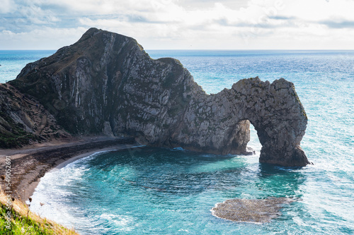 Views of natural rock formations Durdle door in Lulworth, Dorset, United Kingdom. Part of Jurassic Coast World Heritage Site, view of stone arch and blue sea, selective focus