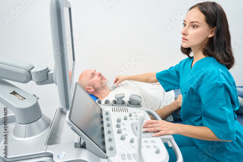 Woman conducts an ultrasound examination of organs of endocrine system