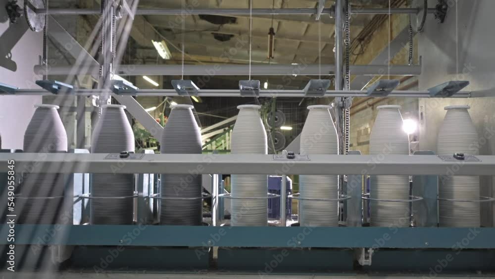 Timelapse of Cotton yarn on bobbin. Spool of thread closeup on clothing factory. Textile fabric. Industrial equipment. Knitwear production Timelapse of Cotton yarn on bobbin. Spool of thread closeup on clothing factory. Textile fabric. Industrial equipment. Knitwear production