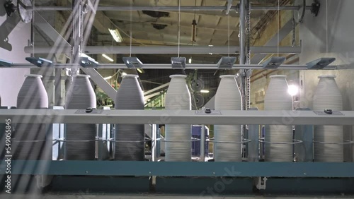 Timelapse of Cotton yarn on bobbin. Spool of thread closeup on clothing factory. Textile fabric. Industrial equipment. Knitwear production