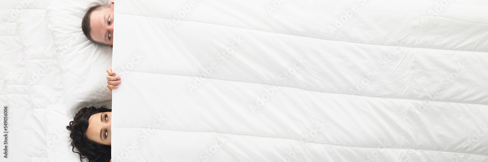 Ταπετσαρία Woman and man peeking on each other under white blanket, awake couple in bed