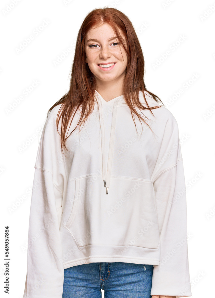 Young read head woman wearing casual sweatshirt looking positive and happy standing and smiling with a confident smile showing teeth Young read head woman wearing casual sweatshirt looking positive and happy standing and smiling with a confident smile showing teeth