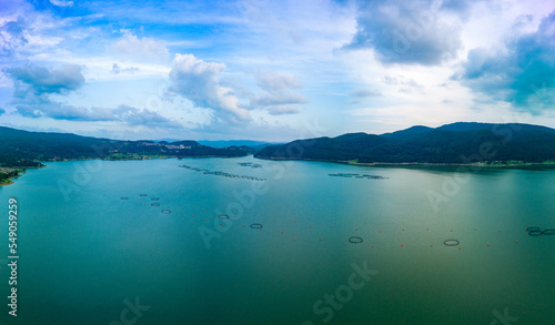 Breeding of freshwater fish in lake with round nets. Rhodope mountains, Europe. Panorama, top view