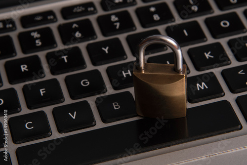 internet and computer security represented by a closed padlock over a black keyboard