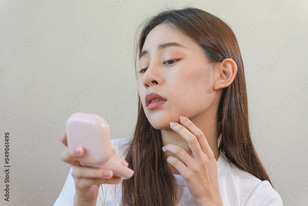skin problem treatment. Women looking acne on her face in the mirror. skin problem treatment. Women looking acne on her face in the mirror.