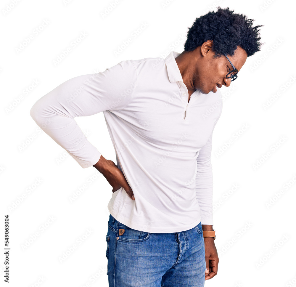 Handsome african american man with afro hair wearing casual clothes and glasses suffering of backache, touching back with hand, muscular pain Handsome african american man with afro hair wearing casual clothes and glasses suffering of backache, touching back with hand, muscular pain