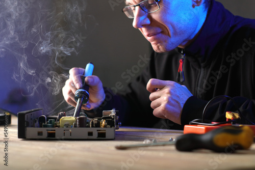 repair of an old satellite tuner by a person on a table