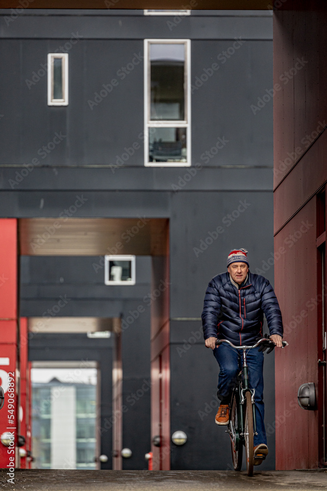 Copenhagen, Denmark A man bikes in a modern housing complex in the south harbor district. Copenhagen, Denmark A man bikes in a modern housing complex in the south harbor district.