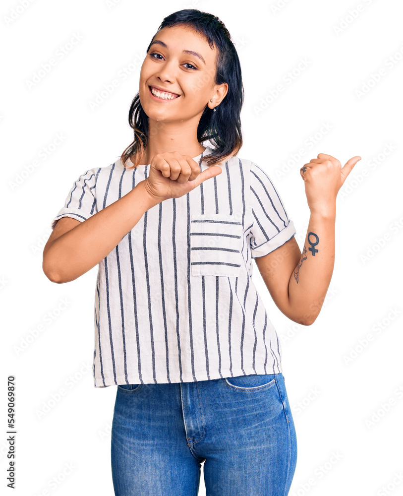 Young woman wearing casual clothes pointing to the back behind with hand and thumbs up, smiling confident Young woman wearing casual clothes pointing to the back behind with hand and thumbs up, smiling confident
