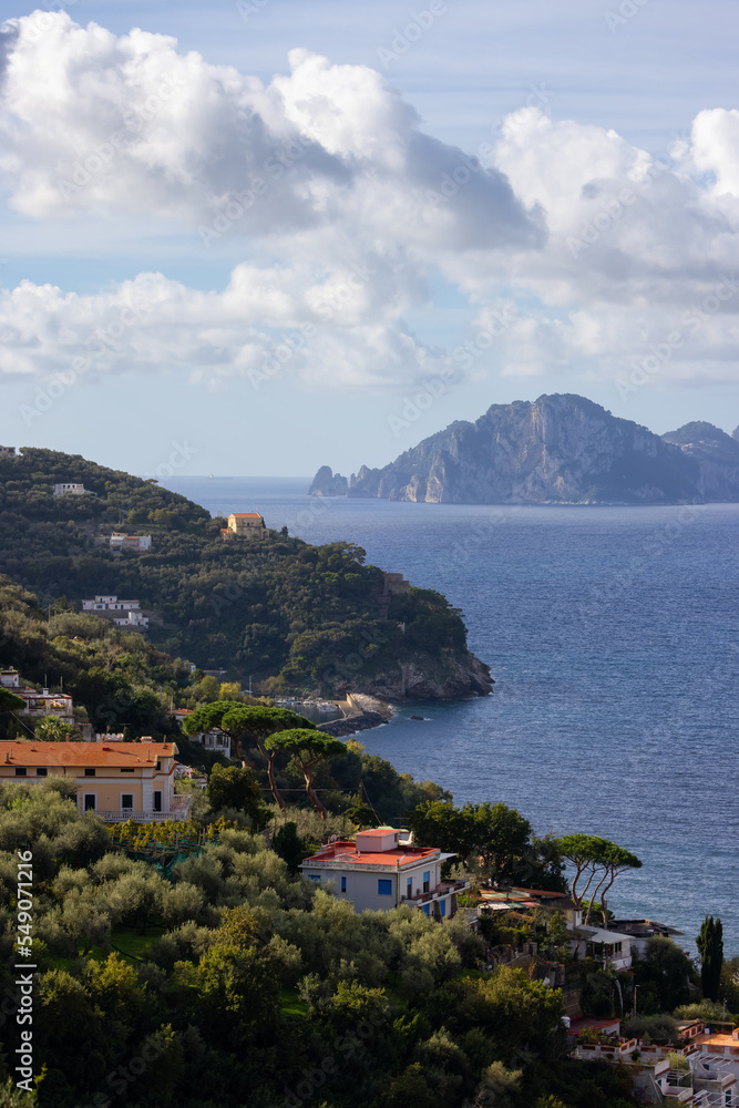 Residential Homes on Mountain by the Sea with Capri Island in background. Near Touristic Town of Sorrento, Italy.