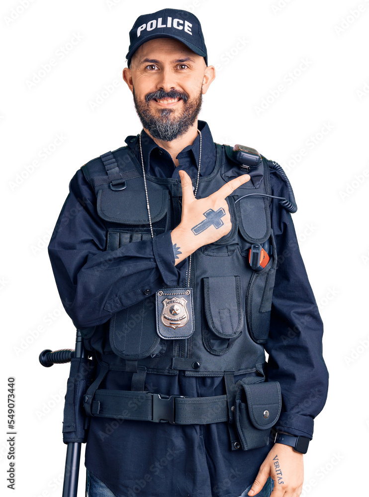 Young handsome man wearing police uniform cheerful with a smile on face pointing with hand and finger up to the side with happy and natural expression Young handsome man wearing police uniform cheerful with a smile on face pointing with hand and finger up to the side with happy and natural expression