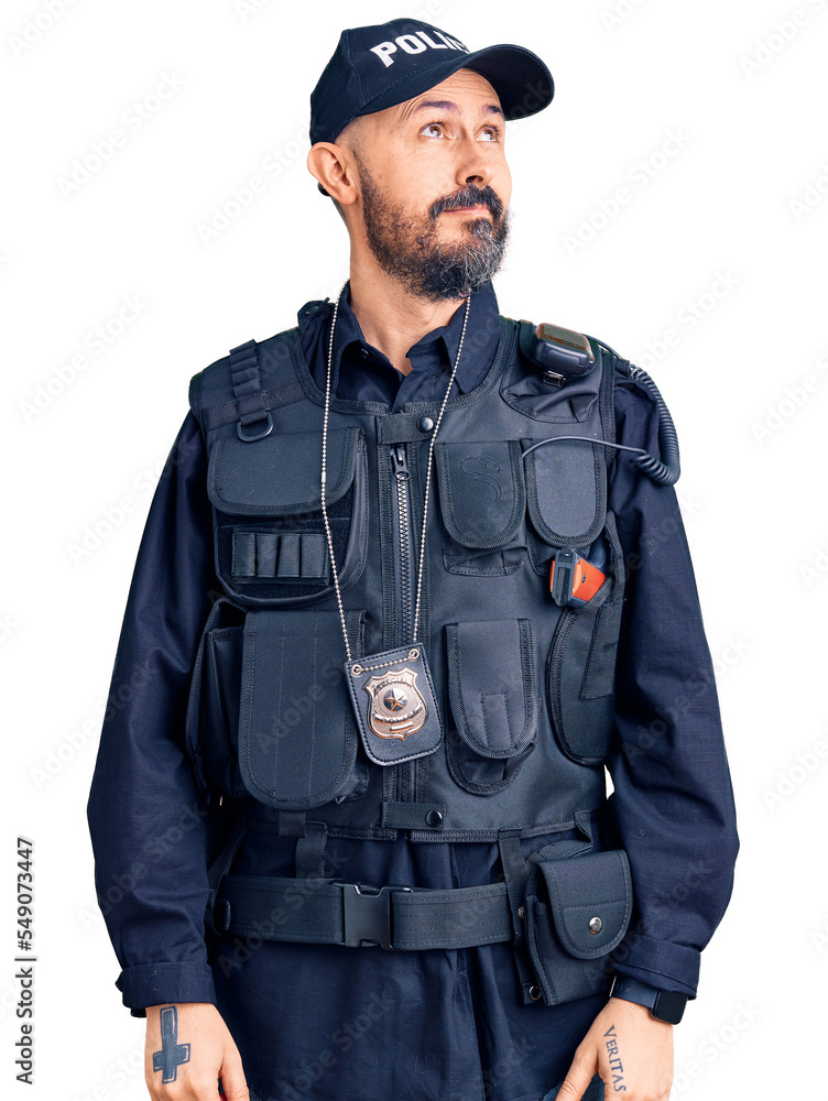 Young handsome man wearing police uniform smiling looking to the side and staring away thinking. Young handsome man wearing police uniform smiling looking to the side and staring away thinking.
