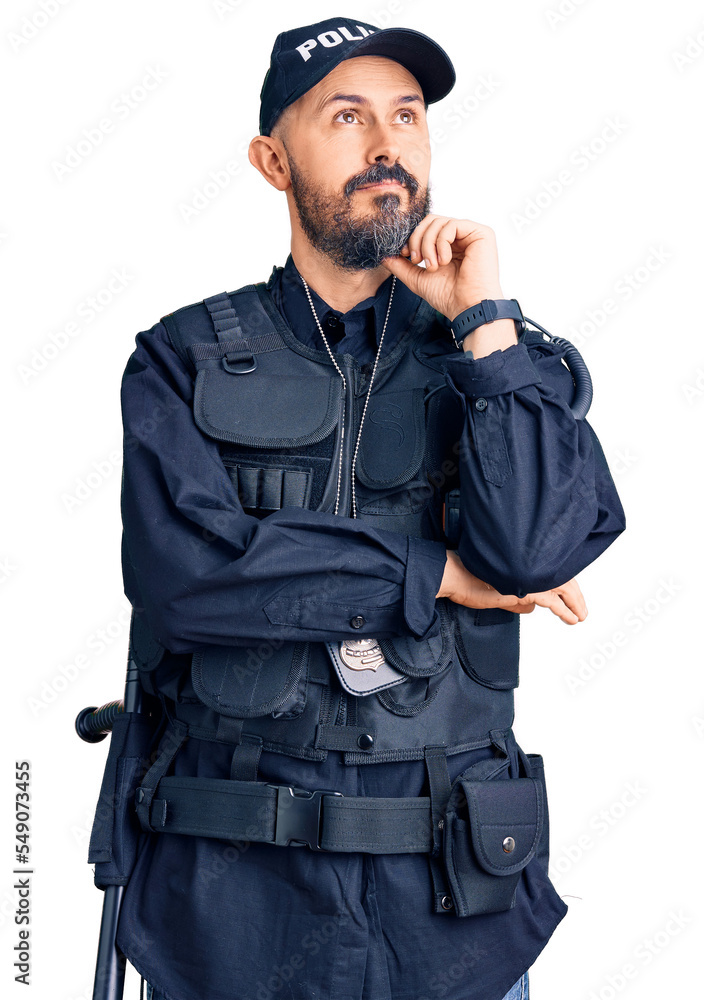 Young handsome man wearing police uniform with hand on chin thinking about question, pensive expression. smiling and thoughtful face. doubt concept. Young handsome man wearing police uniform with hand on chin thinking about question, pensive expression. smiling and thoughtful face. doubt concept.