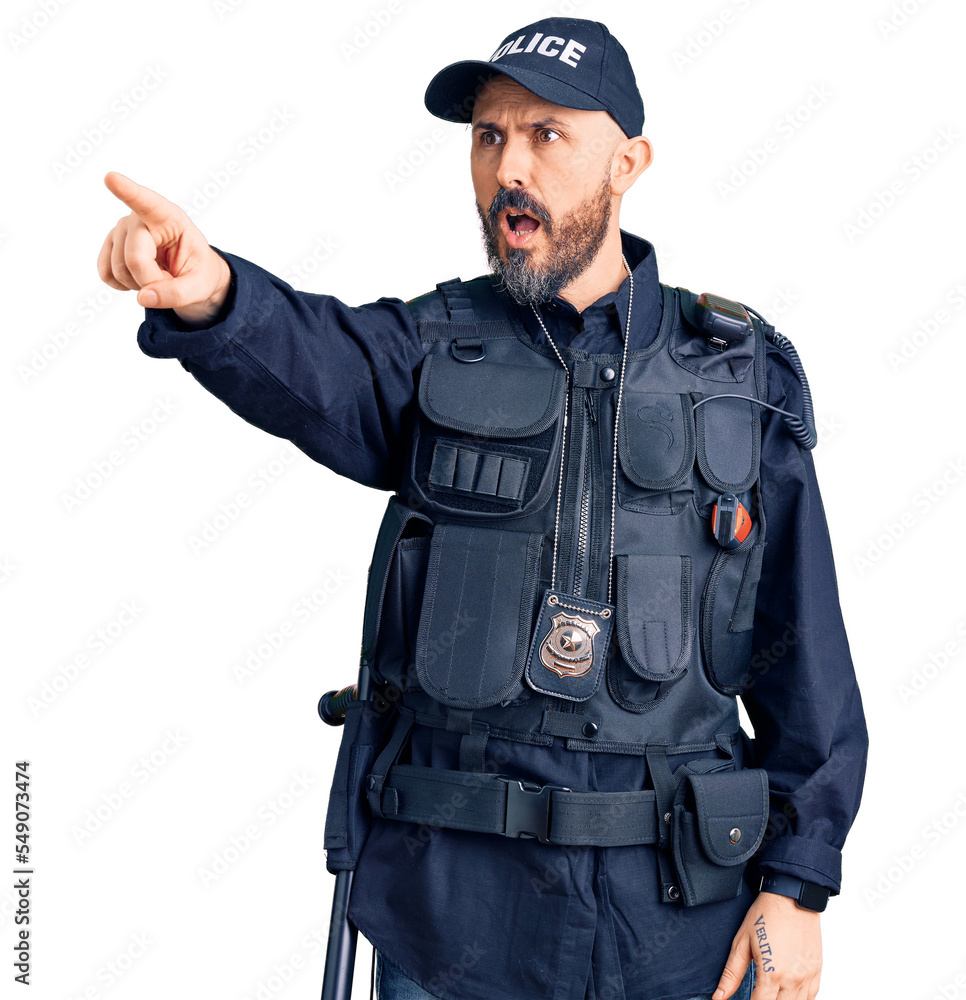 Young handsome man wearing police uniform pointing with finger surprised ahead, open mouth amazed expression, something on the front Young handsome man wearing police uniform pointing with finger surprised ahead, open mouth amazed expression, something on the front