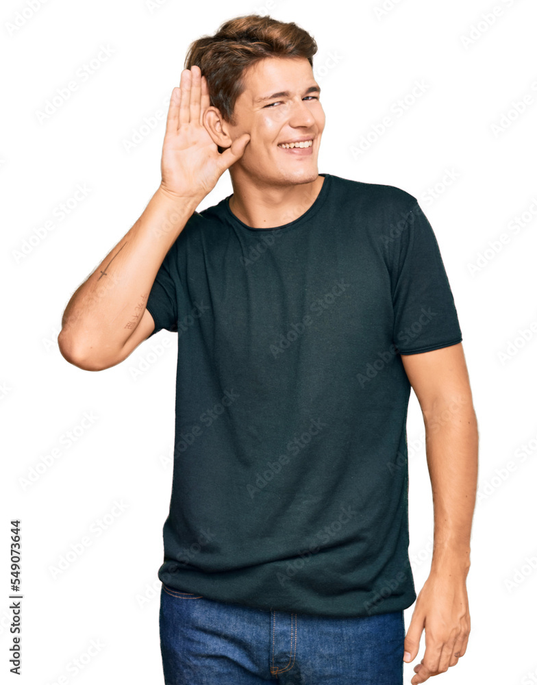 Handsome caucasian man wearing casual clothes smiling with hand over ear listening an hearing to rumor or gossip. deafness concept. Handsome caucasian man wearing casual clothes smiling with hand over ear listening an hearing to rumor or gossip. deafness concept.