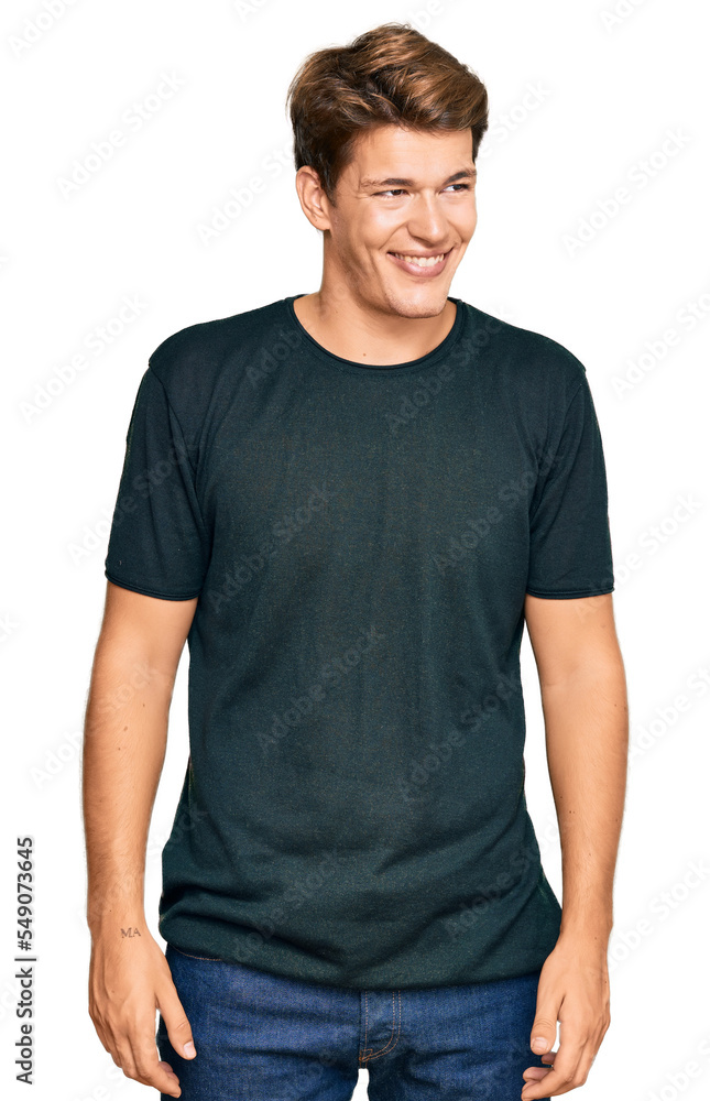 Handsome caucasian man wearing casual clothes looking away to side with smile on face, natural expression. laughing confident. Handsome caucasian man wearing casual clothes looking away to side with smile on face, natural expression. laughing confident.