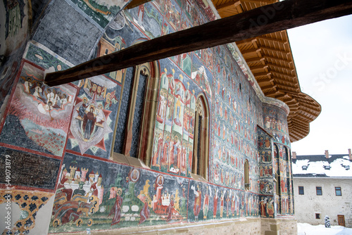 Sucevita, Romania, 2021-12-29. Sucevita Monastery in the Bukovina region under the snow. Their exterior walls are composed of frescoes painted in the 15th and 16th centuries, representing portraits of photo