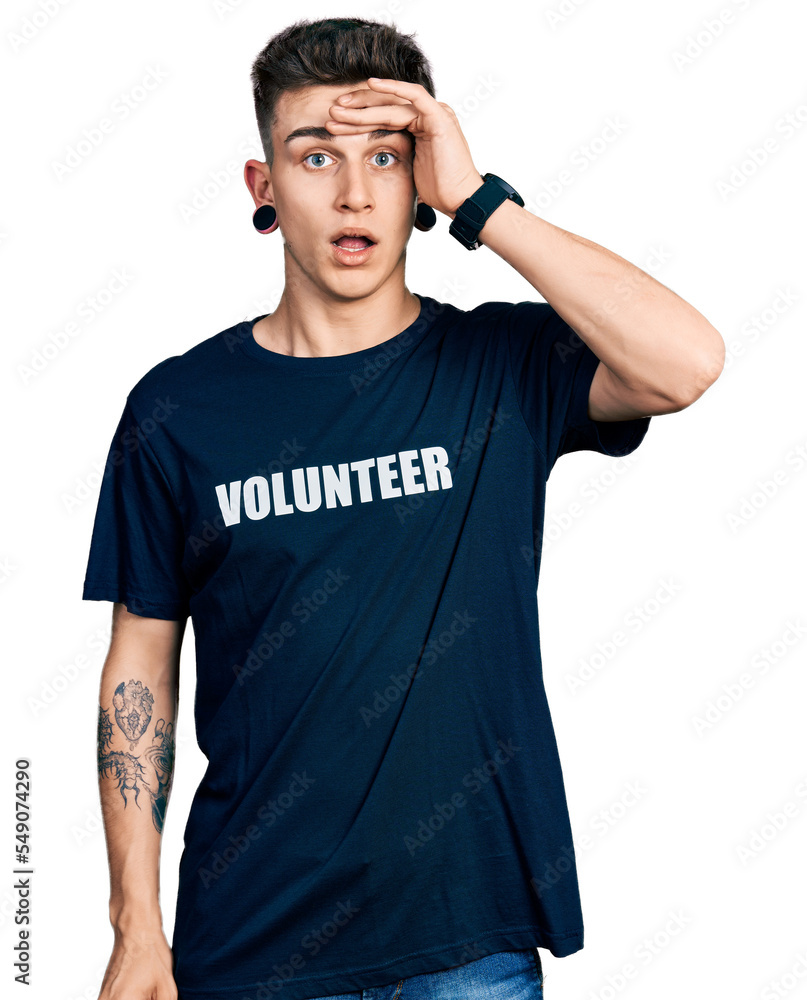 Young caucasian boy with ears dilation wearing volunteer t shirt surprised with hand on head for mistake, remember error. forgot, bad memory concept. Young caucasian boy with ears dilation wearing volunteer t shirt surprised with hand on head for mistake, remember error. forgot, bad memory concept.