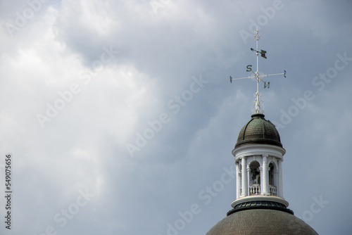 A wind vane on top of a tower