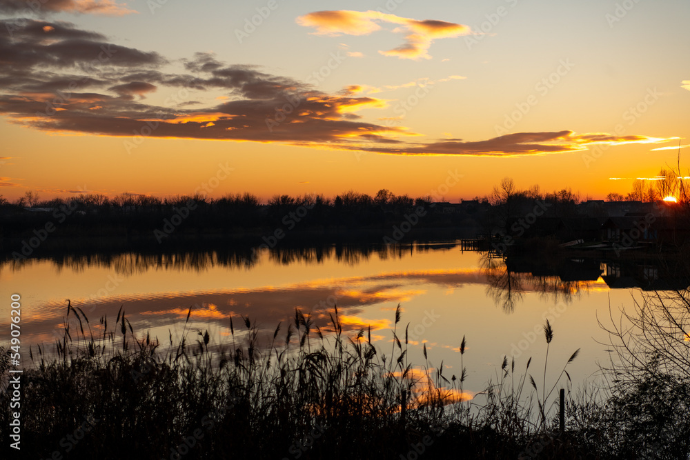 Romania, 2022-01-01. Sunset on a lake in the Bucharest area. Romania, 2022-01-01. Sunset on a lake in the Bucharest area.