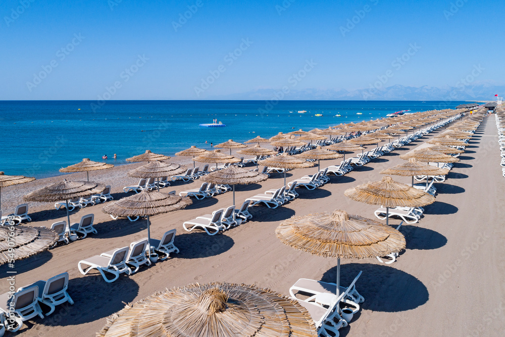 Obraz premium Sandy beaches of the Mediterranean. Kundu - Belek holiday complex with five star hotels. Beach, sea, water sports, parasailing, entertainment and shopping center Aerial view. Antalya, Turkey