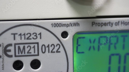 A smart meter flashing LED light, showing energy consumption and power use. 1000 imperial kWh symbol. Concept, cost of living crisis, price rises, heating and fuel. photo