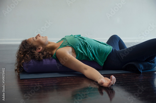 Woman practicing restorative yoga.