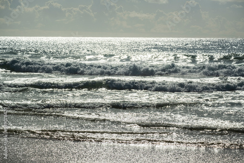 waves in the sea seen at dusk  reflecting the luminosity of the sun