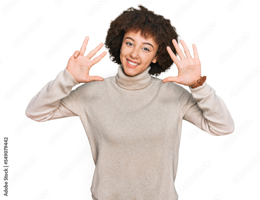 Young hispanic girl wearing wool winter sweater showing and pointing up with fingers number nine while smiling confident and happy. Young hispanic girl wearing wool winter sweater showing and pointing up with fingers number nine while smiling confident and happy.