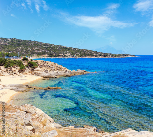 Summer sea scenery with aquamarine transparent water and sandy beaches. View from shore (Sithonia, Halkidiki, Greece).