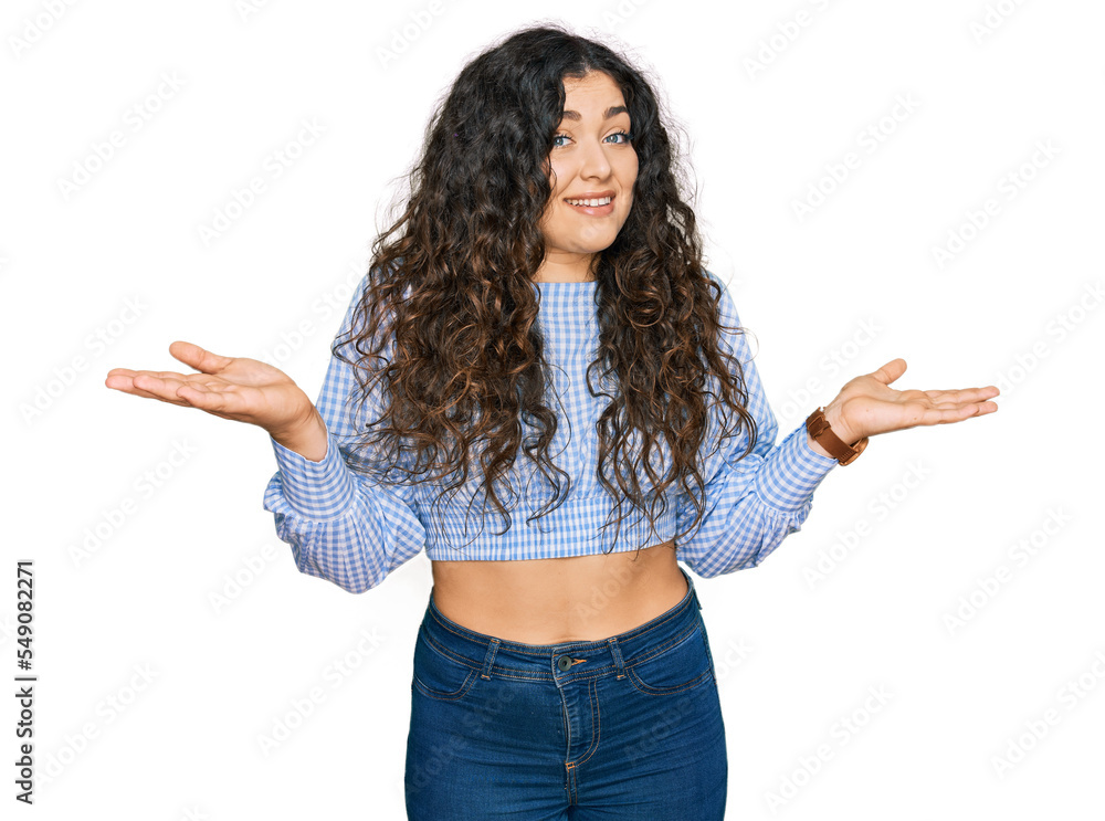 Young hispanic girl wearing casual clothes clueless and confused expression with arms and hands raised. doubt concept. Young hispanic girl wearing casual clothes clueless and confused expression with arms and hands raised. doubt concept.