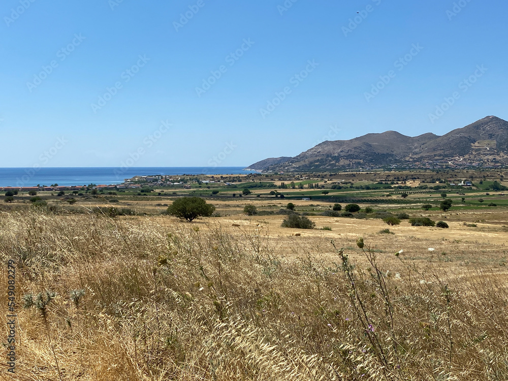 Pastures, mountains, sea and clear sky view  from the southernmost coast of Gökçeada. A landscape view from Gokceada Imbros island,Turkey Islands	