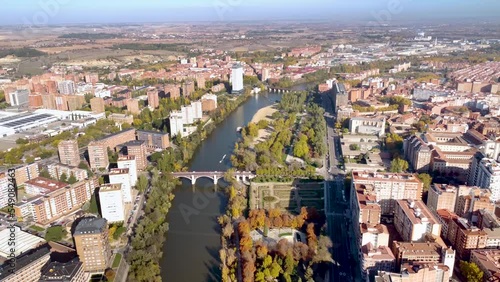 Aerial perspective of Valladolid city. Situated in Spain, in Castilla y Leon Province. View of River Pisuerga and La Rosaleda Park. Drone pull back. Beautiful panorama of whole city. 