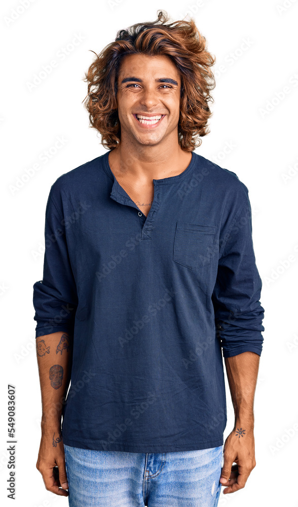 Young hispanic man wearing casual clothes with a happy and cool smile on face. lucky person. Young hispanic man wearing casual clothes with a happy and cool smile on face. lucky person.